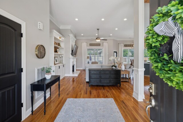 7579 Nightfall Cir, Ooltewah, TN 37363 - entrance foyer featuring a ceiling fan, wood finished floors, recessed lighting, ornamental molding, and a fireplace with raised hearth