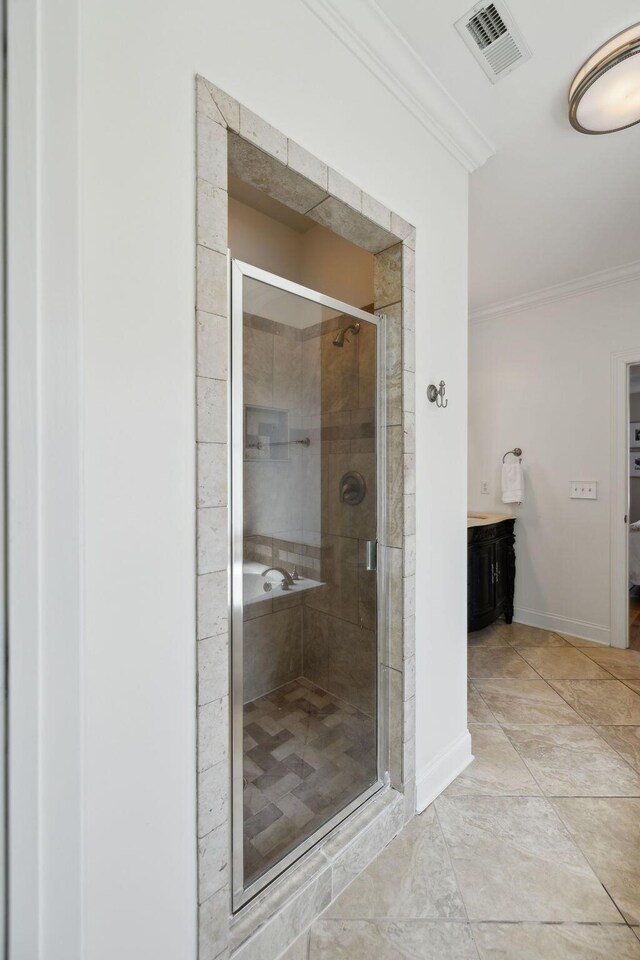 7579 Nightfall Cir, Ooltewah, TN 37363 - bathroom featuring crown molding, a shower stall, vanity, and baseboards