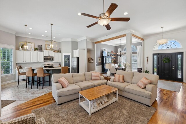 7579 Nightfall Cir, Ooltewah, TN 37363 - living room featuring a chandelier, recessed lighting, light wood-type flooring, baseboards, and a ceiling fan