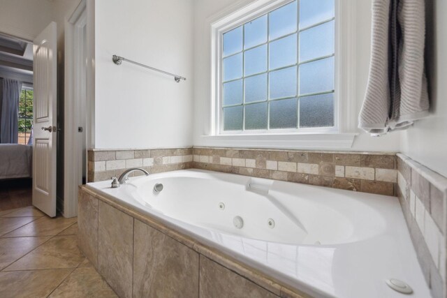 7579 Nightfall Cir, Ooltewah, TN 37363 - ensuite bathroom featuring a whirlpool tub, plenty of natural light, and tile patterned floors