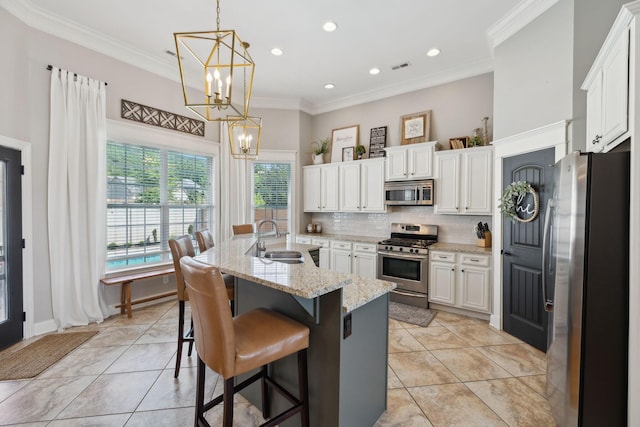 7579 Nightfall Cir, Ooltewah, TN 37363 - kitchen with stainless steel appliances, a sink, a chandelier, decorative backsplash, and ornamental molding