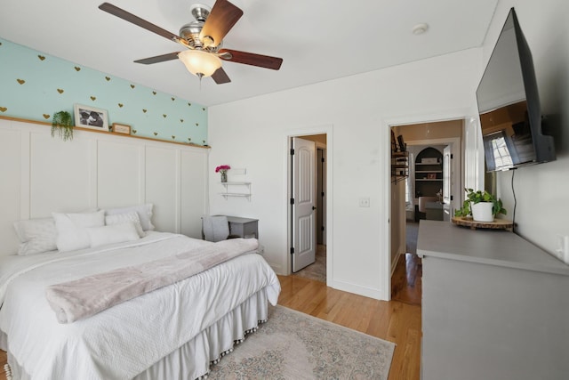 7579 Nightfall Cir, Ooltewah, TN 37363 - bedroom with light wood-type flooring, a ceiling fan, a closet, and a walk in closet