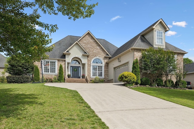 7579 Nightfall Cir, Ooltewah, TN 37363 - traditional-style house featuring concrete driveway, a garage, a front lawn, brick siding, and roof with shingles