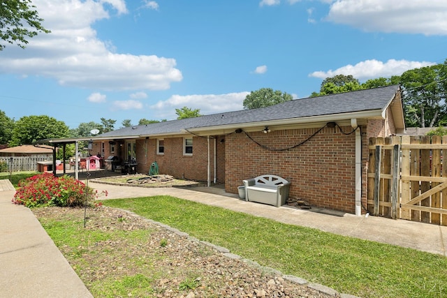 805 Springmont Dr, Hopkinsville, KY 42240 - back of house with a shingled roof, brick siding, a gate, and a patio area