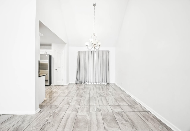 3716 S Jot Dr, Clarksville, TN 37040 - unfurnished dining area featuring a chandelier, baseboards, and high vaulted ceiling