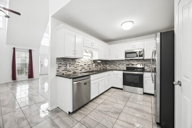 3716 S Jot Dr, Clarksville, TN 37040 - kitchen with appliances with stainless steel finishes, light marble finish floors, a sink, and dark countertops