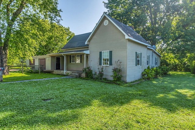 226 Higdon St, Lynnville, TN 38472 - view of front of house with a porch, a front yard, and a shingled roof