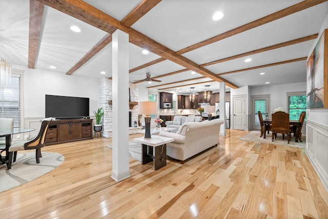 127 Copperstone Dr, Clarksville, TN 37043 - living room with beamed ceiling, ornate columns, light wood-style floors, recessed lighting, and a stone fireplace