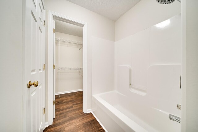 3889 Mackenzie Dr, Clarksville, TN 37042 - full bathroom with a textured ceiling, wood finished floors, tub / shower combination, and a spacious closet