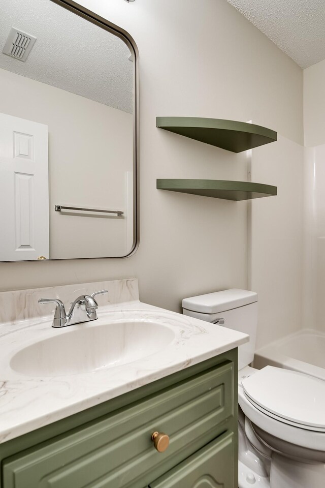 3889 Mackenzie Dr, Clarksville, TN 37042 - bathroom featuring a textured ceiling, toilet, and vanity