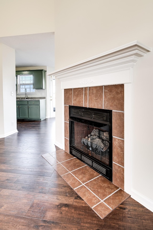 3889 Mackenzie Dr, Clarksville, TN 37042 - detailed view of a tile fireplace, a sink, wood finished floors, and baseboards
