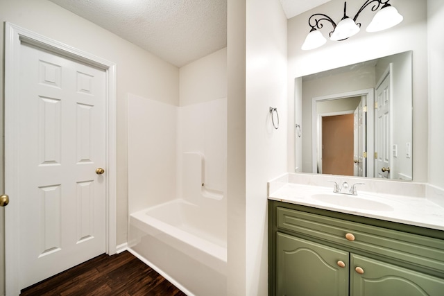 3889 Mackenzie Dr, Clarksville, TN 37042 - full bath with wood finished floors, vanity, a chandelier, a textured ceiling, and bathing tub / shower combination