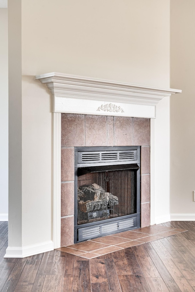3889 Mackenzie Dr, Clarksville, TN 37042 - detailed view of a tile fireplace, wood finished floors, and baseboards