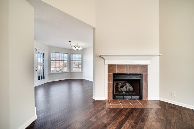 3889 Mackenzie Dr, Clarksville, TN 37042 - unfurnished living room with dark wood-style floors, baseboards, and a chandelier