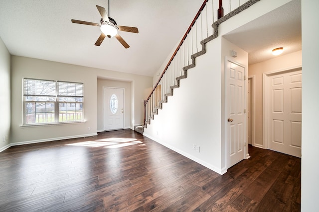 3889 Mackenzie Dr, Clarksville, TN 37042 - entryway with dark wood finished floors, ceiling fan, stairs, baseboards, and vaulted ceiling