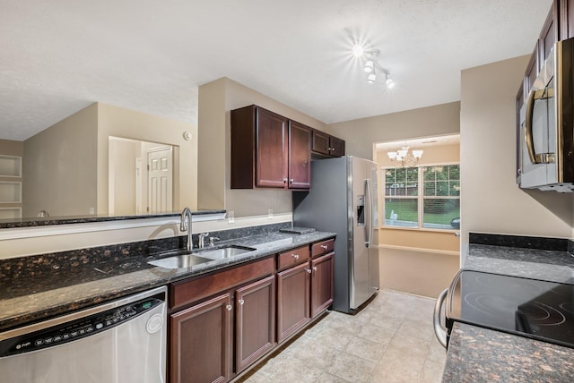 905 Arbor Springs Dr, Mount Juliet, TN 37122 - kitchen featuring stainless steel appliances, a sink, a chandelier, dark stone counters, and rail lighting