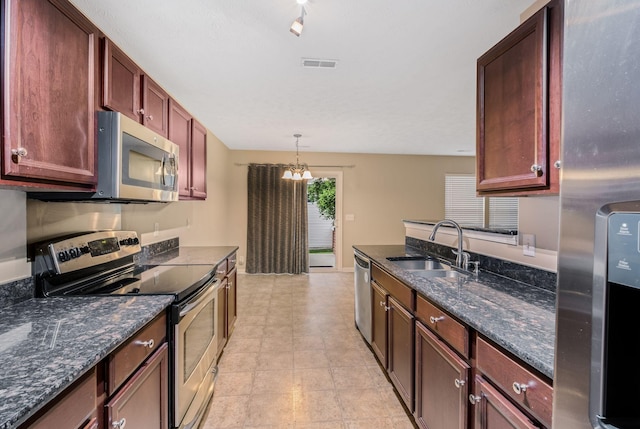 905 Arbor Springs Dr, Mount Juliet, TN 37122 - kitchen featuring appliances with stainless steel finishes, a sink, pendant lighting, dark stone counters, and a chandelier