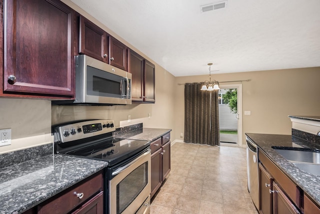 905 Arbor Springs Dr, Mount Juliet, TN 37122 - kitchen with appliances with stainless steel finishes, a sink, a chandelier, decorative light fixtures, and dark stone countertops
