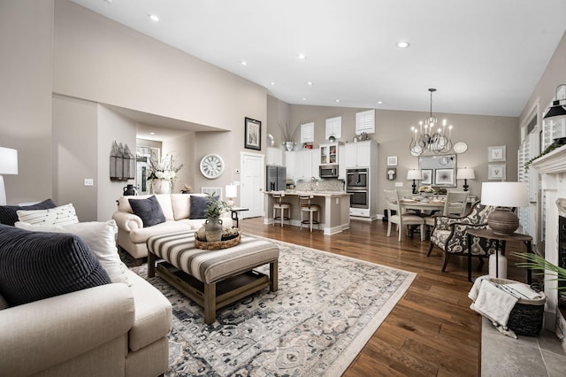 390 Buckingham Blvd, Gallatin, TN 37066 - living area featuring high vaulted ceiling, a chandelier, dark wood-style floors, a high end fireplace, and recessed lighting