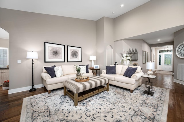 390 Buckingham Blvd, Gallatin, TN 37066 - living room featuring arched walkways, baseboards, wood finished floors, recessed lighting, and a high ceiling