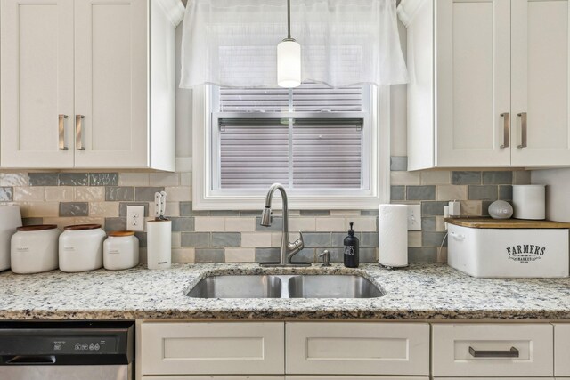 974 Bonellis Ln, Clarksville, TN 37040 - kitchen featuring dishwasher, a sink, white cabinets, tasteful backsplash, and light stone countertops