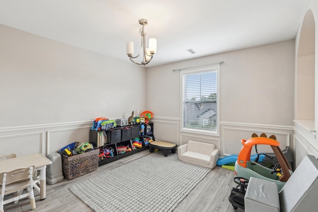 974 Bonellis Ln, Clarksville, TN 37040 - rec room with a chandelier, wainscoting, wood finished floors, and a decorative wall