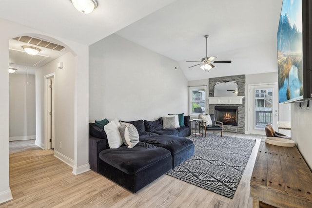 974 Bonellis Ln, Clarksville, TN 37040 - living area with a ceiling fan, wood finished floors, a stone fireplace, baseboards, and vaulted ceiling