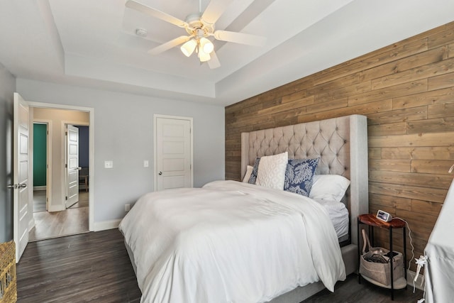 974 Bonellis Ln, Clarksville, TN 37040 - bedroom featuring wood walls, a raised ceiling, dark wood-type flooring, baseboards, and ceiling fan