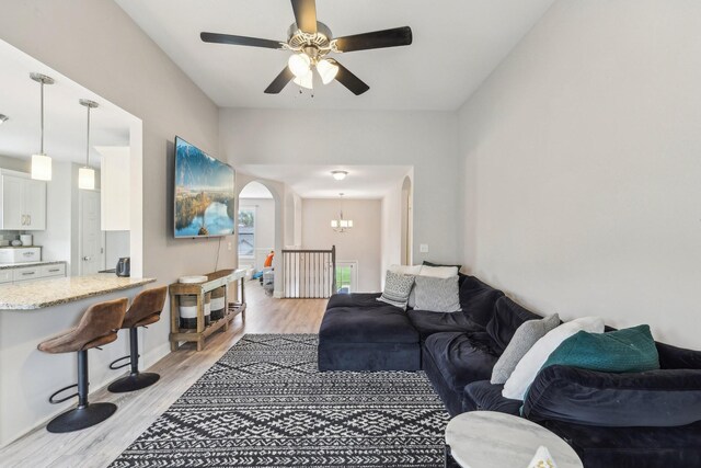 974 Bonellis Ln, Clarksville, TN 37040 - living room with ceiling fan, light wood-style floors, arched walkways, and a chandelier