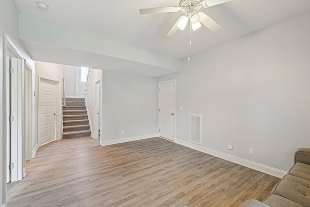 974 Bonellis Ln, Clarksville, TN 37040 - unfurnished living room featuring stairs, light wood finished floors, baseboards, and a ceiling fan