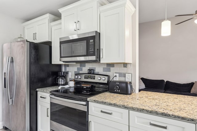 974 Bonellis Ln, Clarksville, TN 37040 - kitchen with stainless steel appliances, white cabinetry, light stone counters, and a ceiling fan