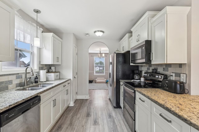 974 Bonellis Ln, Clarksville, TN 37040 - kitchen with stainless steel appliances, a sink, white cabinetry, and light wood-style floors