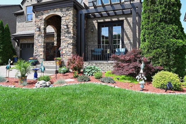 102 Cobbler Cir, Hendersonville, TN 37075 - view of front facade with french doors, brick siding, a front yard, and a garage