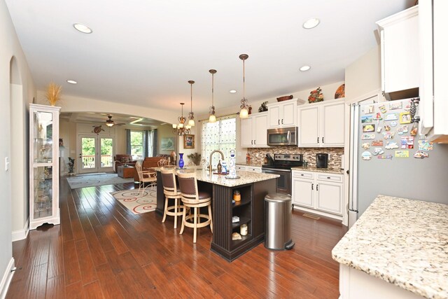 102 Cobbler Cir, Hendersonville, TN 37075 - kitchen with stainless steel appliances, arched walkways, ceiling fan, white cabinetry, and recessed lighting