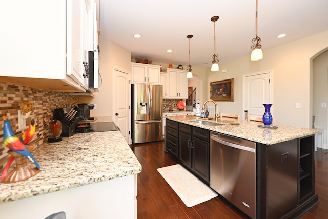 102 Cobbler Cir, Hendersonville, TN 37075 - kitchen with stainless steel appliances, arched walkways, a sink, tasteful backsplash, and white cabinetry