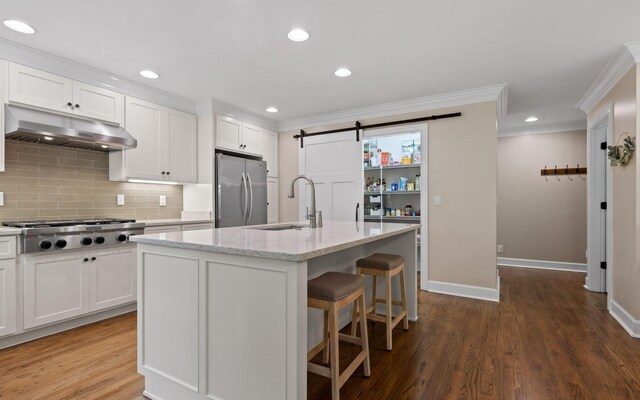 414 Gentlemens Rdg, Signal Mountain, TN 37377 - kitchen featuring under cabinet range hood, a sink, stainless steel appliances, ornamental molding, and white cabinetry