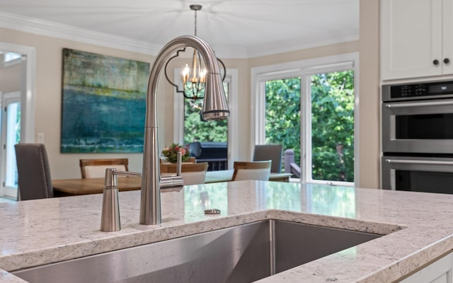 414 Gentlemens Rdg, Signal Mountain, TN 37377 - kitchen with stainless steel double oven, light stone countertops, ornamental molding, a sink, and a chandelier