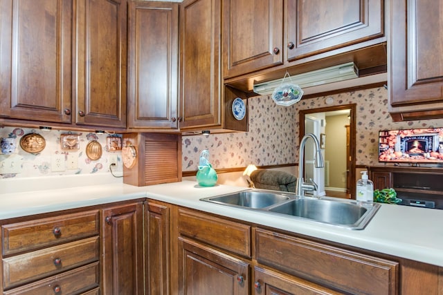 2119 W Lincoln St, Tullahoma, TN 37388 - kitchen with a sink, wallpapered walls, and light countertops