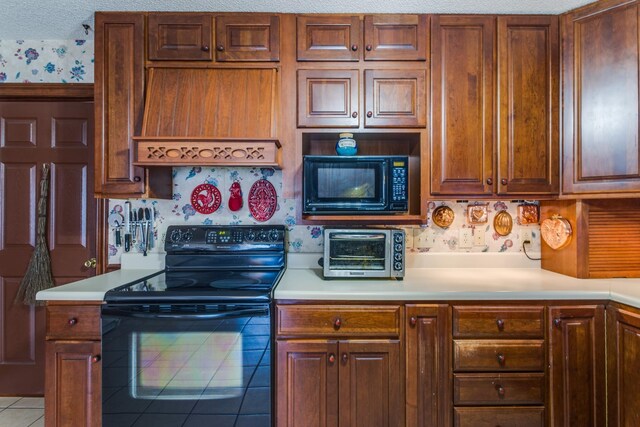 2119 W Lincoln St, Tullahoma, TN 37388 - kitchen with black appliances, light countertops, wallpapered walls, and tile patterned flooring