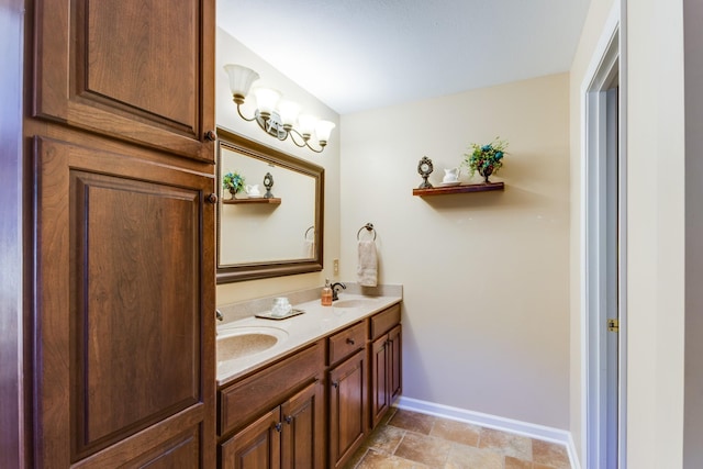 2119 W Lincoln St, Tullahoma, TN 37388 - bathroom featuring double vanity, baseboards, and stone finish flooring