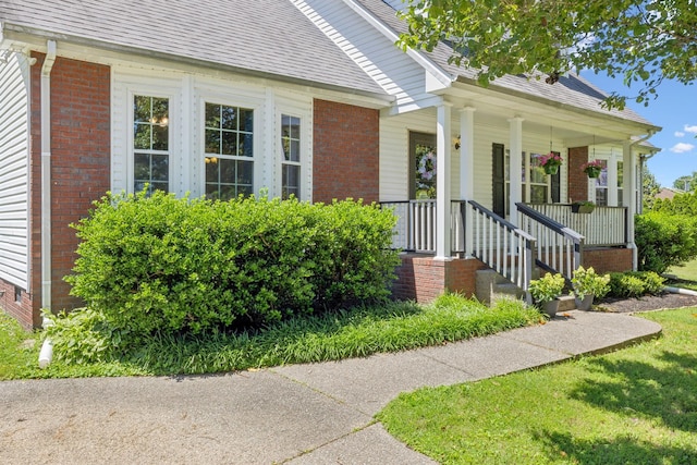 4010 Swift Springs Ct, Goodlettsville, TN 37072 - entrance to property with brick siding, a shingled roof, and covered porch
