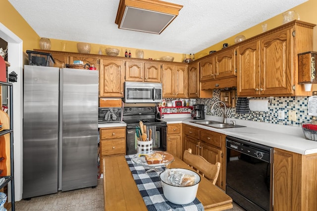 3238 Murphy Ln, Columbia, TN 38401 - kitchen featuring black appliances, a sink, brown cabinetry, light countertops, and a textured ceiling