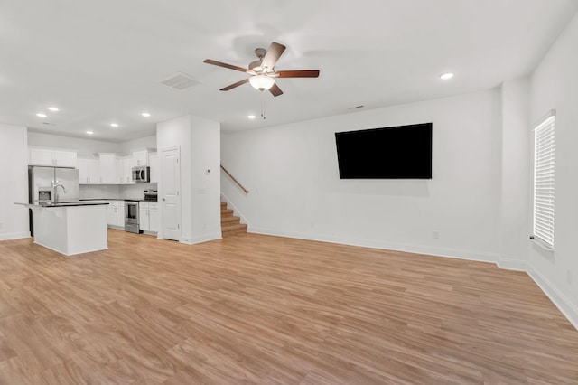 923 SE Broad St Unit A4, Murfreesboro, TN 37130 - unfurnished living room with recessed lighting, a ceiling fan, stairs, and light wood-style flooring