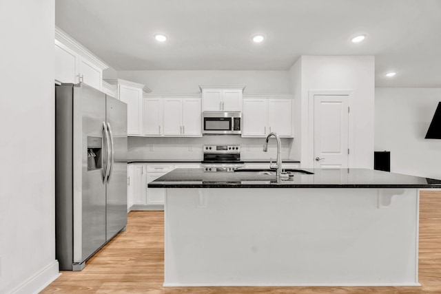 923 SE Broad St Unit A4, Murfreesboro, TN 37130 - kitchen featuring appliances with stainless steel finishes, white cabinets, a center island with sink, light wood finished floors, and recessed lighting