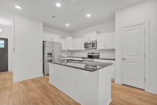 923 SE Broad St Unit A4, Murfreesboro, TN 37130 - kitchen with stainless steel appliances, light wood-style floors, white cabinetry, a kitchen island with sink, and recessed lighting