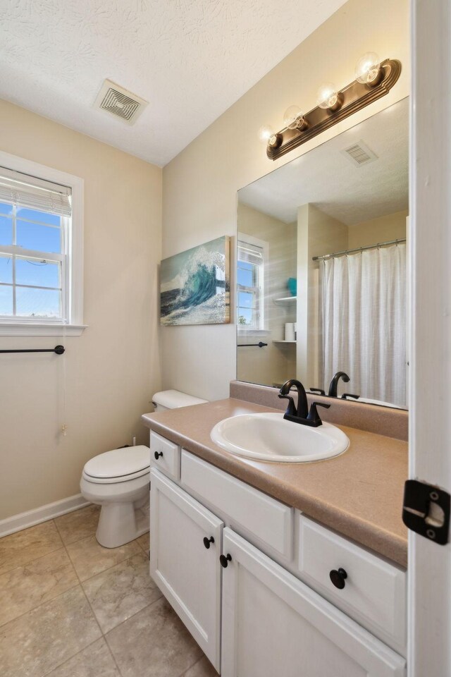8635 Pleasant Hill Rd, Cross Plains, TN 37049 - bathroom featuring vanity, toilet, tile patterned flooring, and baseboards