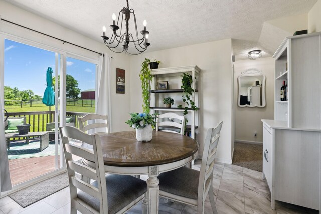 8635 Pleasant Hill Rd, Cross Plains, TN 37049 - dining room with a chandelier, a textured ceiling, and baseboards