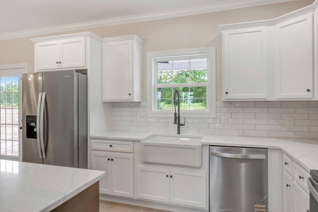 2125 Halls Mill Rd, Unionville, TN 37180 - kitchen with appliances with stainless steel finishes, a sink, crown molding, white cabinets, and decorative backsplash