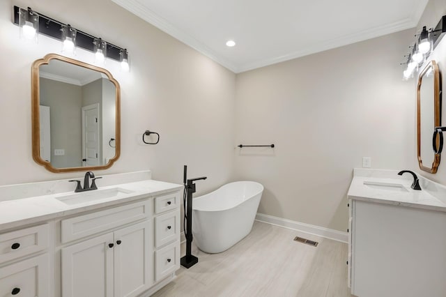 2125 Halls Mill Rd, Unionville, TN 37180 - bathroom featuring crown molding, two vanities, a freestanding tub, baseboards, and recessed lighting