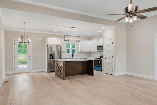 2125 Halls Mill Rd, Unionville, TN 37180 - kitchen with stainless steel appliances, a center island, light wood-type flooring, a ceiling fan, and light countertops